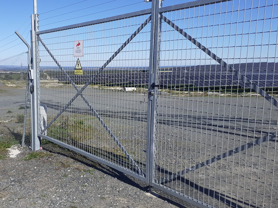 Large double metal gate at the solar park equipped with electronic locking technology